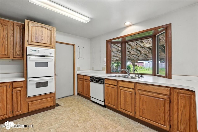 275 S Hoyt St, Anchorage, AK 99508 - kitchen featuring white appliances, light countertops, brown cabinets, and recessed lighting