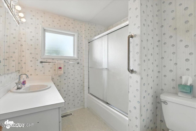 275 S Hoyt St, Anchorage, AK 99508 - bathroom with wallpapered walls, bath / shower combo with glass door, and vanity