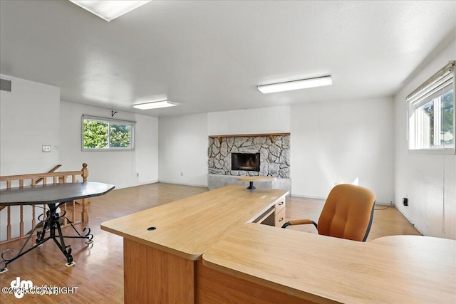 275 S Hoyt St, Anchorage, AK 99508 - home office featuring a stone fireplace and light wood finished floors