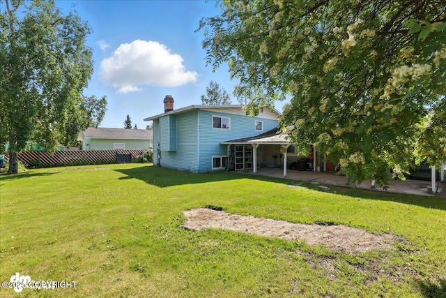 275 S Hoyt St, Anchorage, AK 99508 - back of property featuring a patio area and a chimney