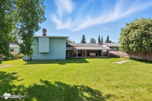 275 S Hoyt St, Anchorage, AK 99508 - back of house with a chimney and a patio area