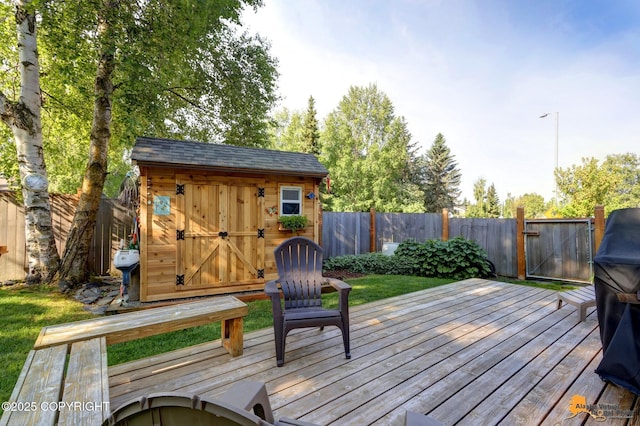 9606 Reliance Dr, Anchorage, AK 99507 - wooden deck featuring a fenced backyard, a storage shed, and a gate
