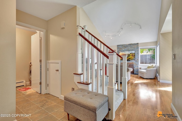 9606 Reliance Dr, Anchorage, AK 99507 - staircase featuring a baseboard heating unit and rail lighting