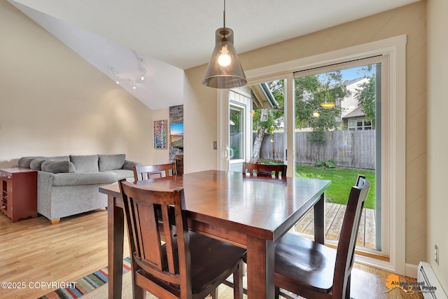 9606 Reliance Dr, Anchorage, AK 99507 - dining room with baseboard heating, light wood-style floors, and lofted ceiling