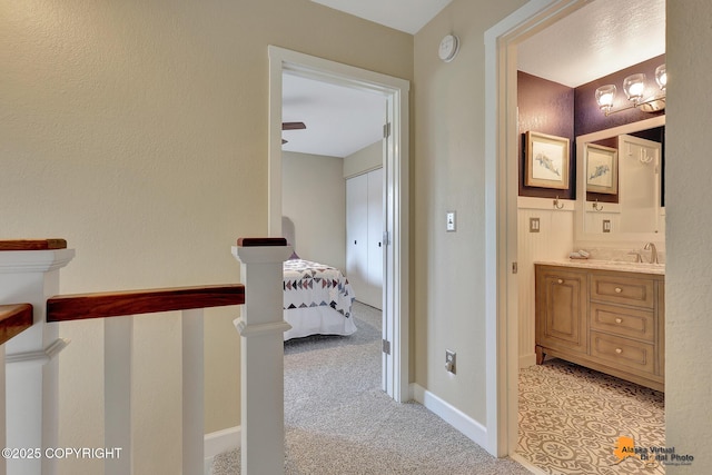 9606 Reliance Dr, Anchorage, AK 99507 - hall with light colored carpet and an upstairs landing