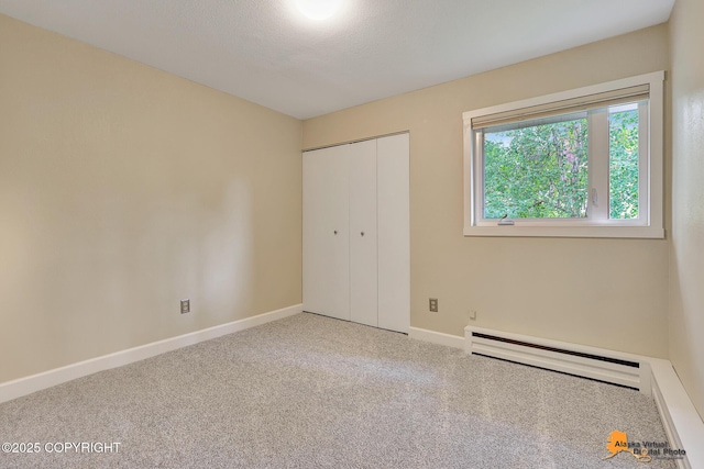 9606 Reliance Dr, Anchorage, AK 99507 - unfurnished bedroom featuring baseboard heating, carpet flooring, and a closet
