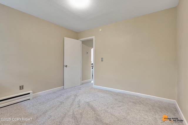 9606 Reliance Dr, Anchorage, AK 99507 - unfurnished room featuring a baseboard heating unit and carpet flooring