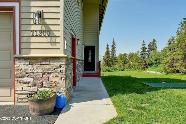 11300 Browder Ave, Anchorage, AK 99507 - view of exterior entry featuring a yard and stone siding