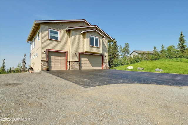 11300 Browder Ave, Anchorage, AK 99507 - view of front of property featuring stone siding, driveway, a garage, and a front yard