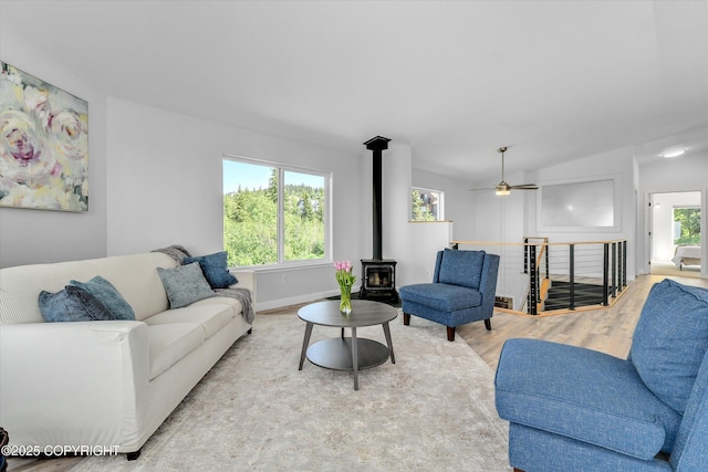 11300 Browder Ave, Anchorage, AK 99507 - living area featuring a wood stove, wood finished floors, and ceiling fan