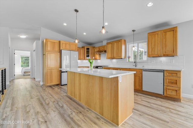 11300 Browder Ave, Anchorage, AK 99507 - kitchen with dishwashing machine, refrigerator, light wood-style flooring, light countertops, and lofted ceiling