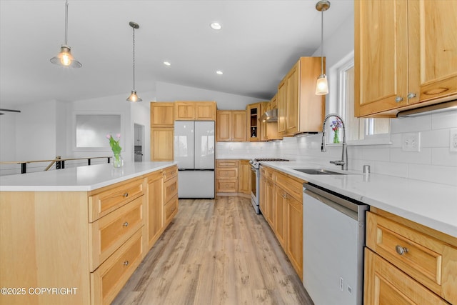 11300 Browder Ave, Anchorage, AK 99507 - kitchen featuring freestanding refrigerator, dishwashing machine, stainless steel gas stove, decorative backsplash, and lofted ceiling