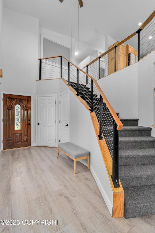 11300 Browder Ave, Anchorage, AK 99507 - stairway featuring a high ceiling, wood finished floors, recessed lighting, and a ceiling fan