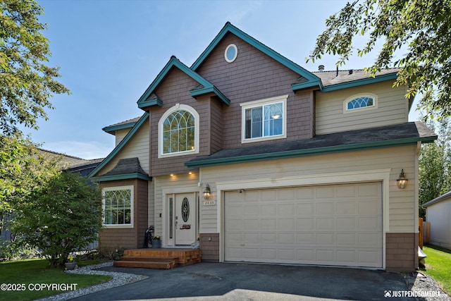 2439 Maritime Loop, Anchorage, AK 99515 - view of front of home featuring an attached garage and asphalt driveway