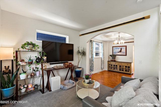 2439 Maritime Loop, Anchorage, AK 99515 - living area with arched walkways, a chandelier, and wood finished floors