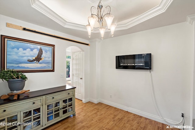 2439 Maritime Loop, Anchorage, AK 99515 - sitting room with arched walkways, a tray ceiling, light wood-style floors, and crown molding