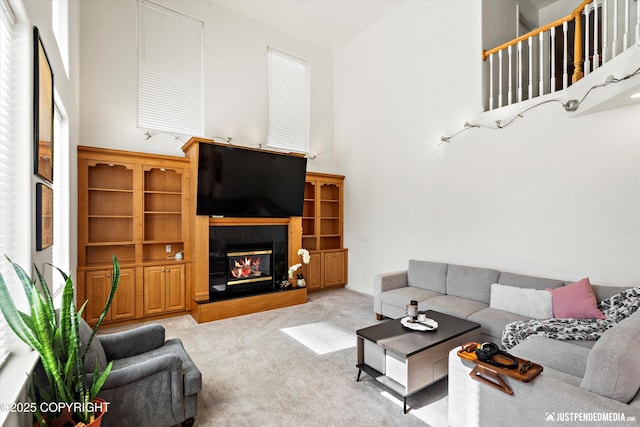 2439 Maritime Loop, Anchorage, AK 99515 - carpeted living area with high vaulted ceiling and a glass covered fireplace