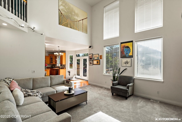 2439 Maritime Loop, Anchorage, AK 99515 - living room with a towering ceiling, a chandelier, and light carpet