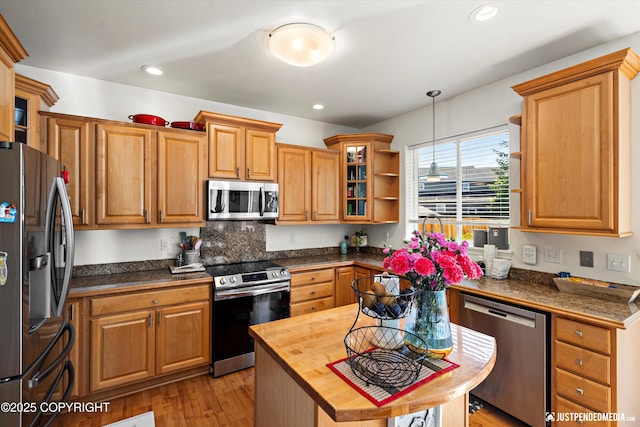 2439 Maritime Loop, Anchorage, AK 99515 - kitchen featuring appliances with stainless steel finishes, open shelves, butcher block countertops, decorative light fixtures, and light wood finished floors