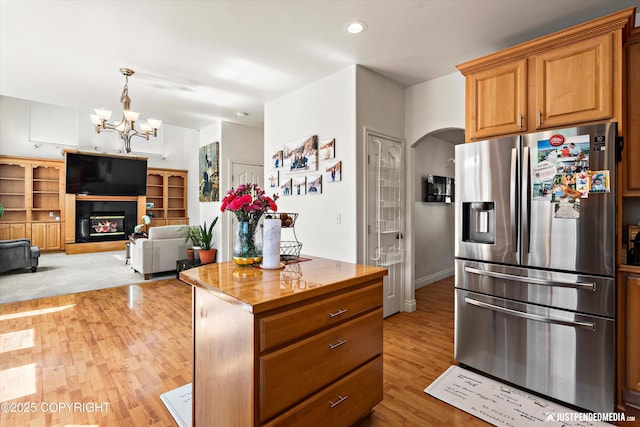 2439 Maritime Loop, Anchorage, AK 99515 - kitchen featuring stainless steel fridge, wood counters, light wood-type flooring, a chandelier, and decorative light fixtures