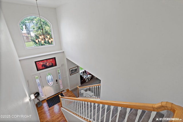 2439 Maritime Loop, Anchorage, AK 99515 - foyer featuring a chandelier, wood finished floors, a towering ceiling, and stairway