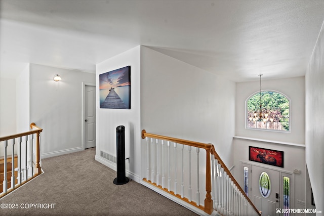 2439 Maritime Loop, Anchorage, AK 99515 - hall featuring an upstairs landing, carpet flooring, and a chandelier