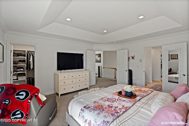 2439 Maritime Loop, Anchorage, AK 99515 - bedroom with a tray ceiling, a walk in closet, light colored carpet, ornamental molding, and a closet