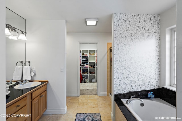 2439 Maritime Loop, Anchorage, AK 99515 - full bathroom featuring vanity, a spacious closet, a garden tub, and a shower stall
