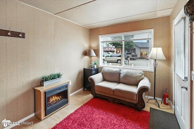 45552 Spruce Ave # 123, Soldotna, AK 99669 - living room with wood finished floors, wood walls, and a lit fireplace