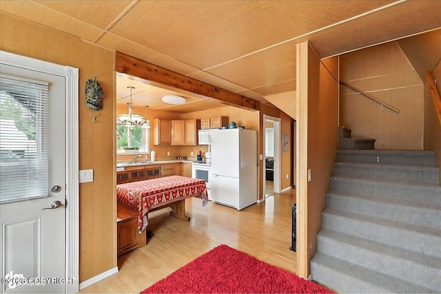 45552 Spruce Ave # 123, Soldotna, AK 99669 - kitchen featuring white appliances, light wood finished floors, light countertops, a chandelier, and light brown cabinetry