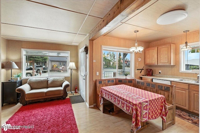 45552 Spruce Ave # 123, Soldotna, AK 99669 - dining space with light wood-style floors, a chandelier, and wooden walls