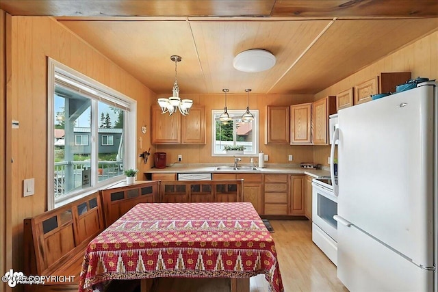 45552 Spruce Ave # 123, Soldotna, AK 99669 - kitchen featuring white appliances, light countertops, light wood-type flooring, a chandelier, and pendant lighting