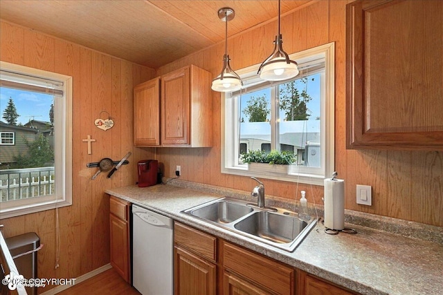 45552 Spruce Ave # 123, Soldotna, AK 99669 - kitchen with white dishwasher, plenty of natural light, wooden walls, decorative light fixtures, and brown cabinets