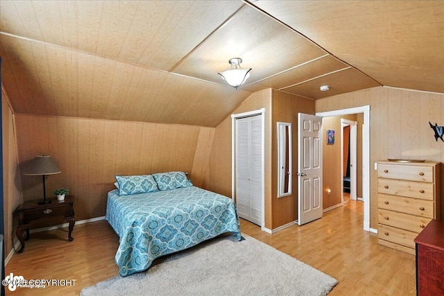 45552 Spruce Ave # 123, Soldotna, AK 99669 - bedroom featuring wooden walls, a closet, lofted ceiling, and wood finished floors