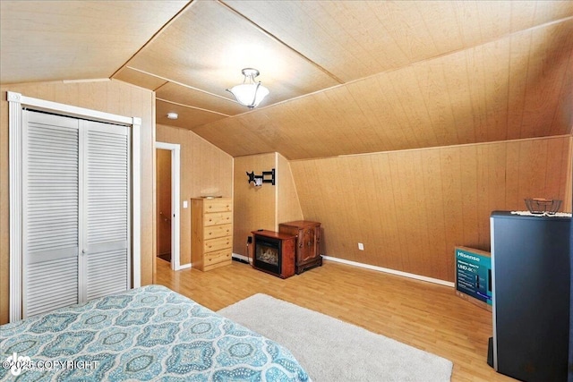 45552 Spruce Ave # 123, Soldotna, AK 99669 - bedroom with wood finished floors, a closet, vaulted ceiling, and wooden walls