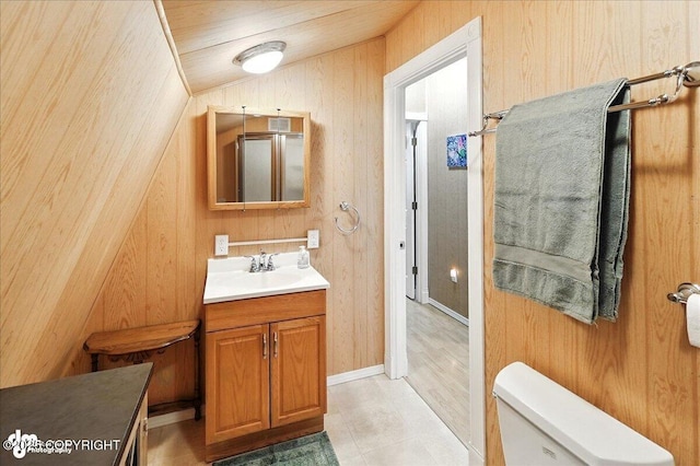 45552 Spruce Ave # 123, Soldotna, AK 99669 - bathroom featuring vanity, vaulted ceiling, and wooden walls