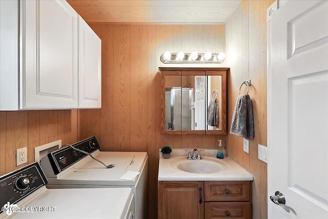 45552 Spruce Ave # 123, Soldotna, AK 99669 - laundry room featuring independent washer and dryer, cabinet space, and wood walls