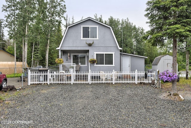 45552 Spruce Ave # 123, Soldotna, AK 99669 - dutch colonial with a gambrel roof, a storage shed, and view of scattered trees