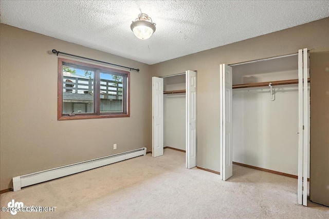 3681 E 20th Ave, Anchorage, AK 99508 - unfurnished bedroom featuring a baseboard radiator, two closets, light colored carpet, and a textured ceiling