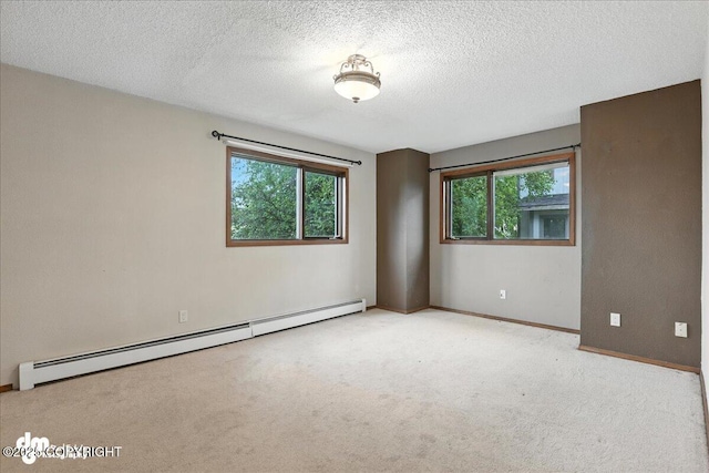 3681 E 20th Ave, Anchorage, AK 99508 - spare room with a baseboard heating unit, carpet floors, plenty of natural light, and a textured ceiling