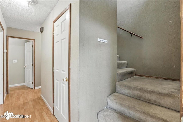 3681 E 20th Ave, Anchorage, AK 99508 - stairs featuring wood finished floors and a textured ceiling