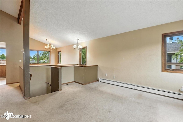 3681 E 20th Ave, Anchorage, AK 99508 - spare room featuring a chandelier, baseboard heating, healthy amount of natural light, vaulted ceiling, and a textured ceiling