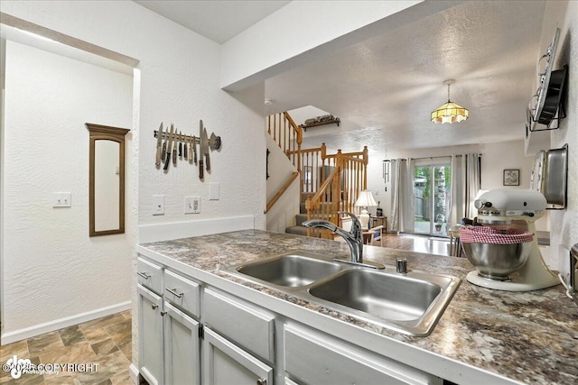 12313 Lake St # C-7, Eagle River, AK 99577 - kitchen with light stone finish flooring, a textured wall, pendant lighting, and gray cabinetry