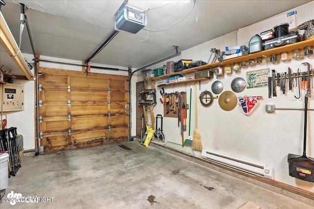 12313 Lake St # C-7, Eagle River, AK 99577 - garage featuring a baseboard radiator, a garage door opener, and electric panel