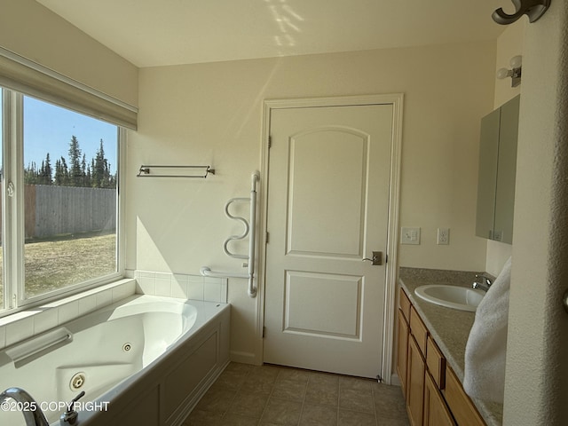 123 Green Valley St, Soldotna, AK 99669 - full bathroom featuring vanity, a jetted tub, and tile patterned flooring