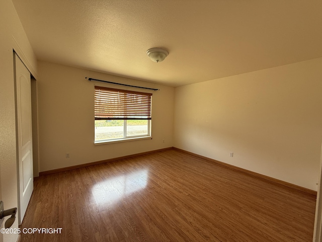 123 Green Valley St, Soldotna, AK 99669 - empty room with wood finished floors and baseboards
