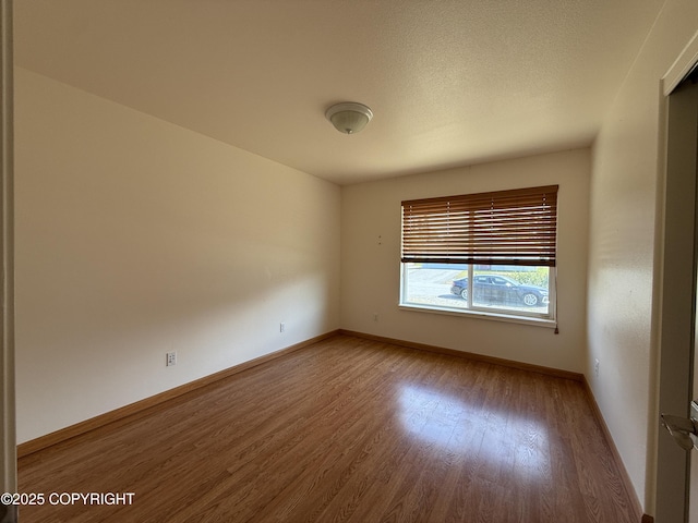 123 Green Valley St, Soldotna, AK 99669 - unfurnished room with wood finished floors and baseboards