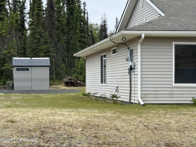 123 Green Valley St, Soldotna, AK 99669 - view of side of property with a shingled roof, a shed, and a lawn