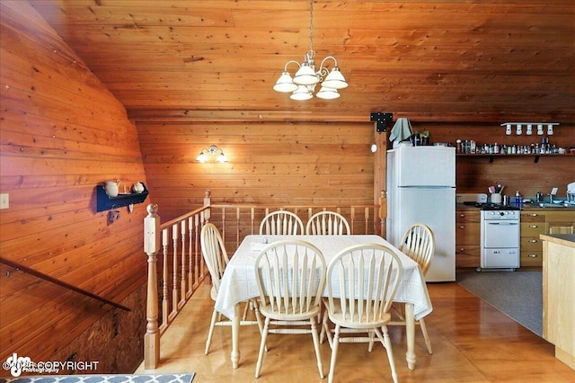 64320 Trail Rd, Anchor Point, AK 99556 - dining space with a chandelier, lofted ceiling, wood walls, wood ceiling, and wood finished floors