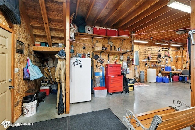 64320 Trail Rd, Anchor Point, AK 99556 - below grade area featuring refrigerator and a workshop area